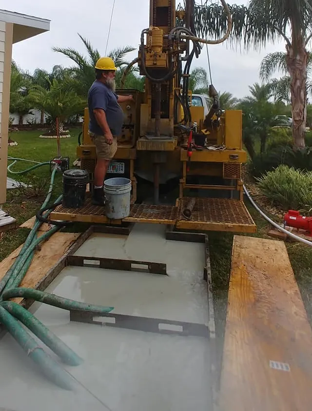 WaterCare driller operating a truck-mounted rig over a contained drilling fluid pit